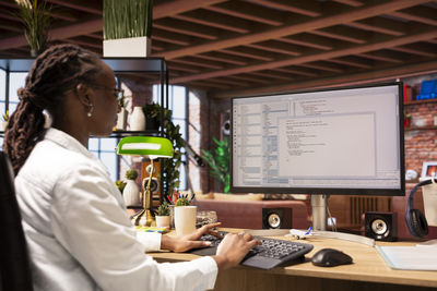 Young woman using laptop at office
