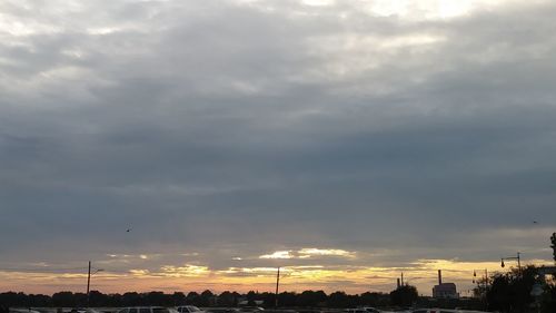 Low angle view of silhouette city against sky at sunset