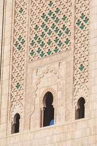 Low angle view of cross on window of historic building