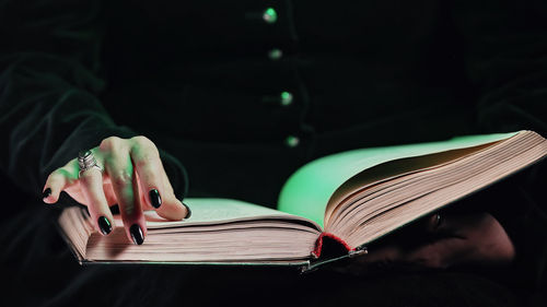 Midsection of woman reading book