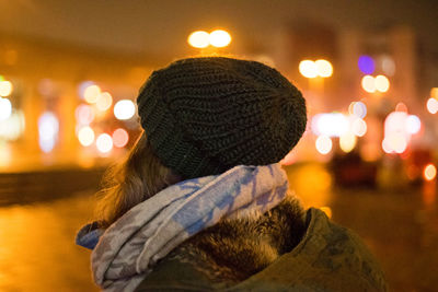 Rear view of woman in illuminated park during winter