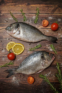 Fresh dorado fish. dorado and ingredients for cooking on a wooden table