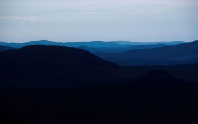 Scenic view of silhouette mountains against sky