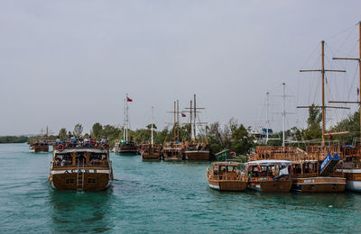 Boats moored on sea against sky