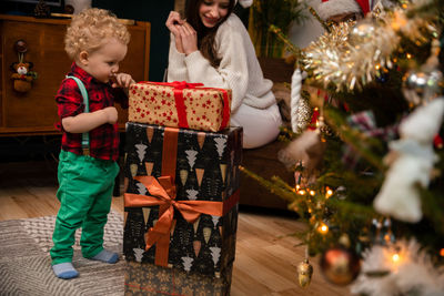 Rear view of woman holding christmas tree