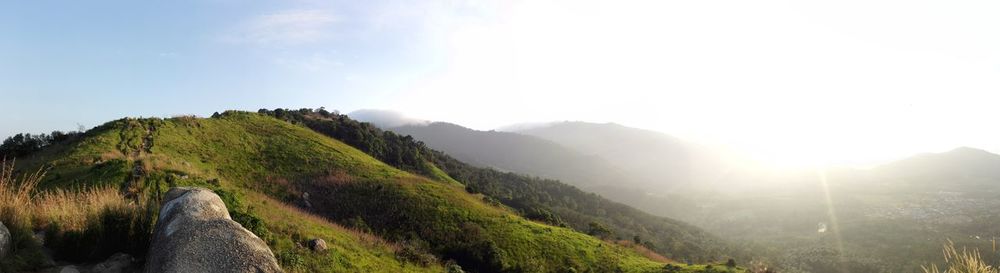 Panoramic shot of countryside landscape against sky on sunny day