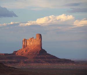 Rock formations on landscape against sky during sunset