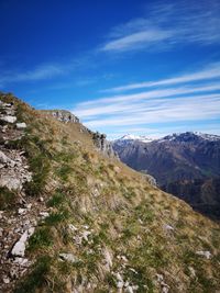 Scenic view of mountains against blue sky