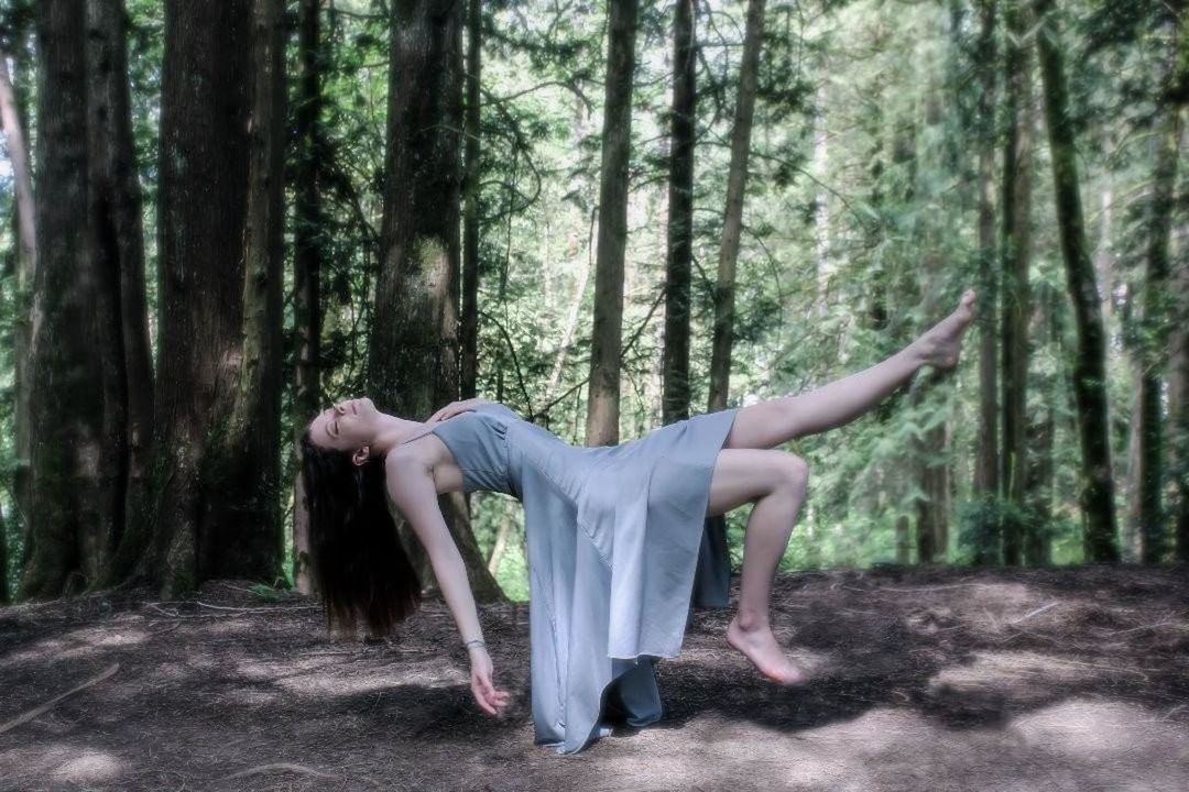 tree, forest, plant, land, one person, full length, nature, woodland, adult, young adult, women, natural environment, lifestyles, clothing, day, tranquility, arm, leisure activity, tree trunk, sports, trunk, balance, limb, outdoors, dancing, flexibility, dress, growth, environment, stretching