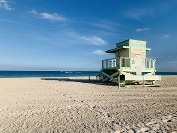 Lifeguard hut on beach against sky