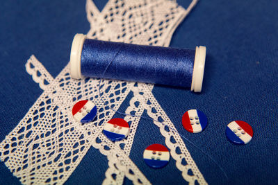 The hardware or workpiece for the sewing of clothes. blue cloth, flax , thread, striped buttons