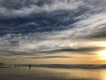 Scenic view of beach against sky during sunset