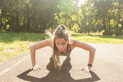 Side view of woman sitting on field