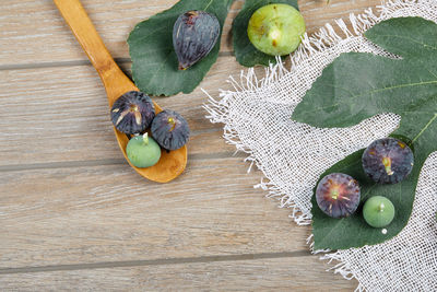 High angle view of fruits and leaves on table