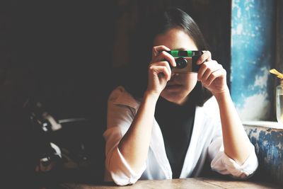 Portrait of woman photographing at home