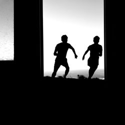 Silhouette men standing against clear sky