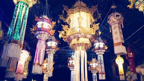 Low angle view of lanterns hanging in temple against sky