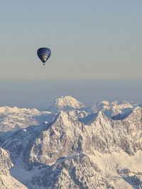 Hot air balloons flying against sky