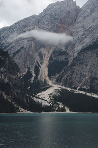 Scenic view of lake by mountains against sky