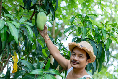 Portrait of woman against tree