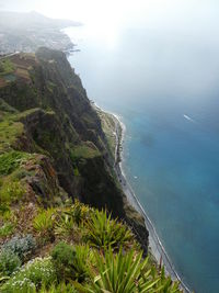 High angle view of sea and mountains against sky