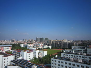 View of cityscape against blue sky