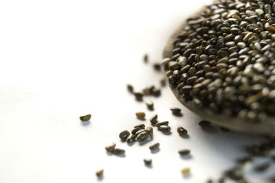 Close-up of roasted coffee beans on white background