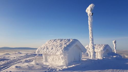 Frozen landscape against clear blue sky