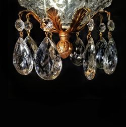 Low angle view of chandelier against black background