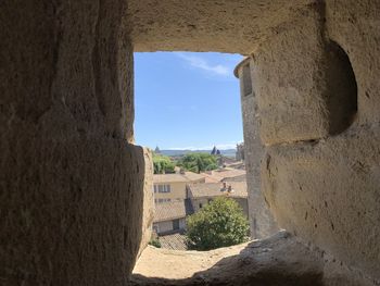 Old building against sky seen through hole