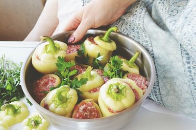 Cropped image of women holding bowl of food