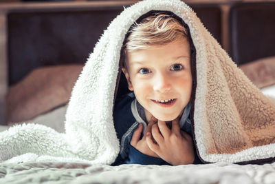 Portrait of cute baby girl on bed at home