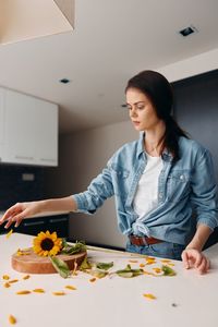 Portrait of young woman sitting at home