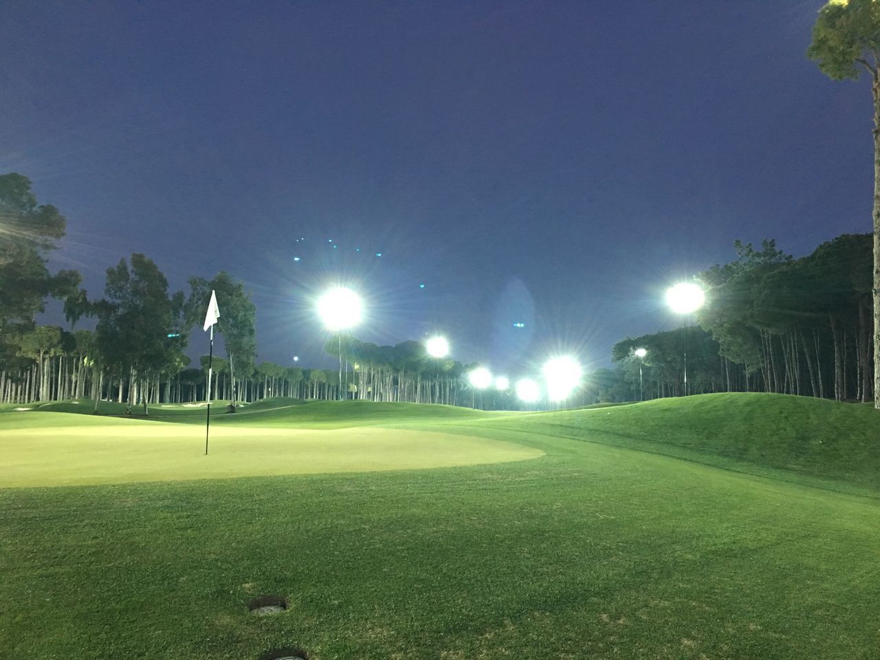 VIEW OF ILLUMINATED STREET AT NIGHT