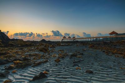 Scenic view of beach against sky during sunset