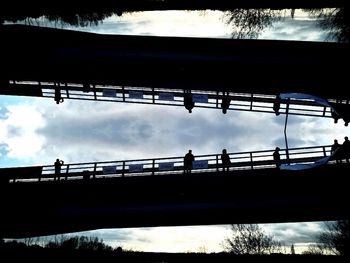 Low angle view of bridge against cloudy sky