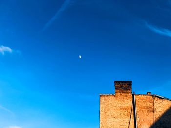 Low angle view of building against blue sky