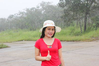 Portrait of woman in hat standing outdoors