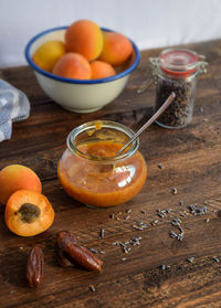 View of preserve with apricot preserves and dates by herb and brown bread