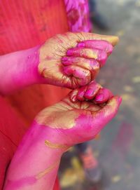 Cropped hands of woman during holi festival