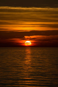 Scenic view of sea against orange sky