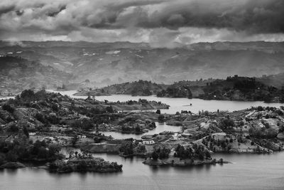 Scenic view of river and landscape against sky