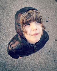 High angle portrait of smiling boy on street