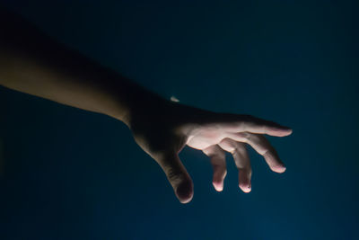 Close-up of hands over blue background