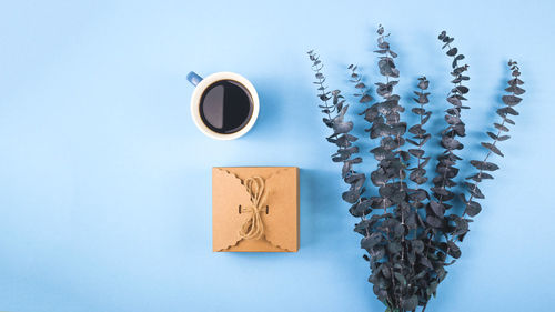 Directly above shot of coffee cup on table against blue background