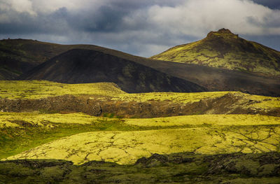 Scenic view of mountains against cloudy sky