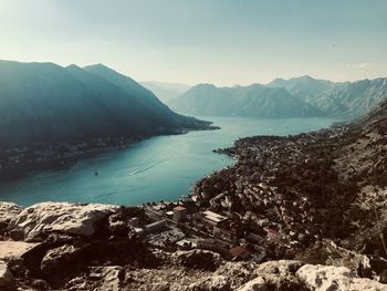 Scenic view of sea and mountains against sky