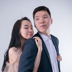 Portrait of young couple against white background