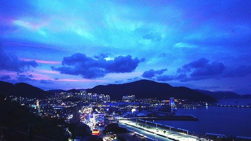 Cityscape against cloudy sky at dusk