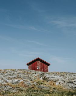 Low angle view of house on hill against sky